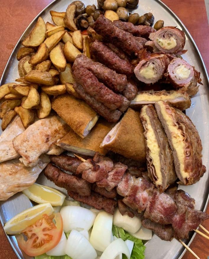 Mixed grill platter with cheese-stuffed pljeskavica and sides at Pivnica Zagorka Zagreb