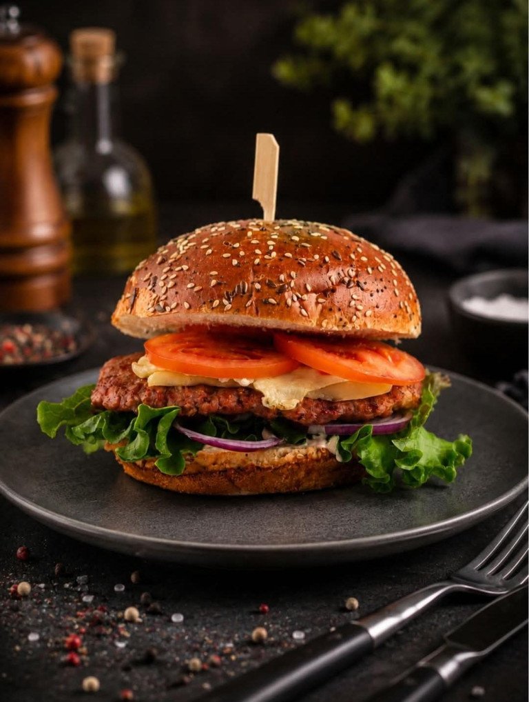 Sočna pljeskavica s roštilja u pecivu sa sezamom, topljenim sirom, rajčicom, crvenim lukom i svježom salatom u restoranu Kruge Grill u Zagrebu